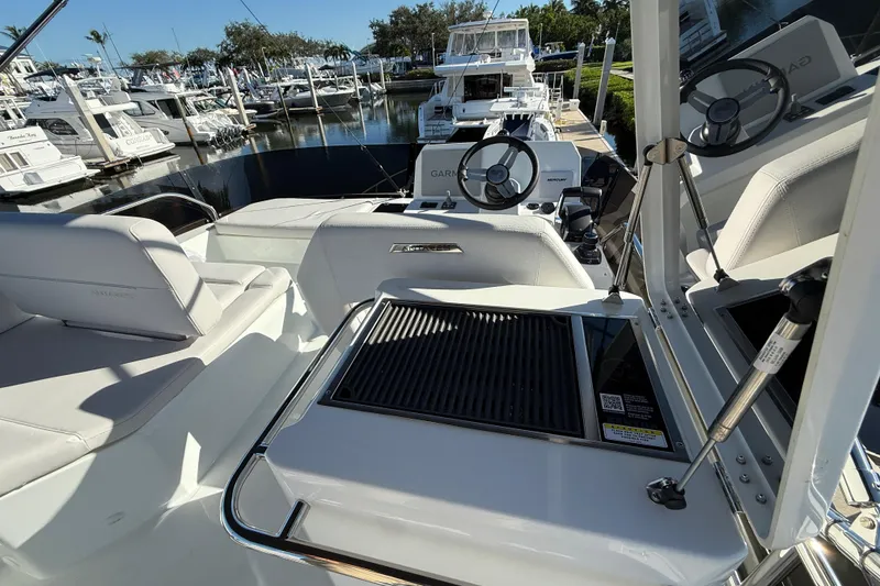 Slide: The Image of 2026 Beneteau Antares 12 yacht interior with seating and steering wheel at marina. - 14