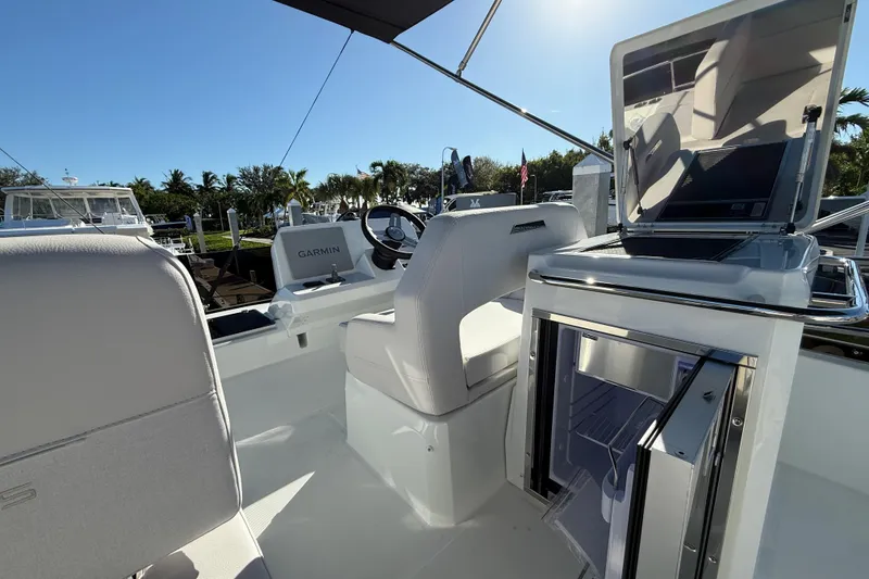 Slide: The Image of 2026 Beneteau Antares 12 cockpit with Garmin navigation, luxurious seating, and open storage compartment. - 15