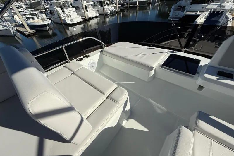Slide: The Image of 2026 Beneteau Antares 12 yacht interior with white seating at marina. - 16