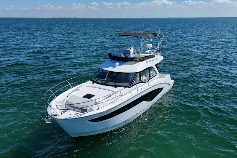 Slide: The Image of 2026 Beneteau Antares 12 yacht cruising on open sea under clear skies. - 2