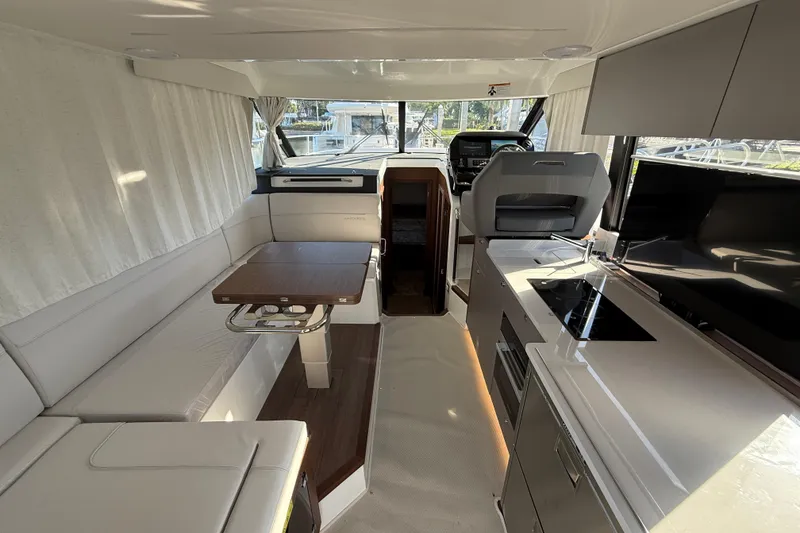 Slide: The Image of Interior of 2026 Beneteau Antares 12 yacht, featuring modern kitchen and seating area. - 20