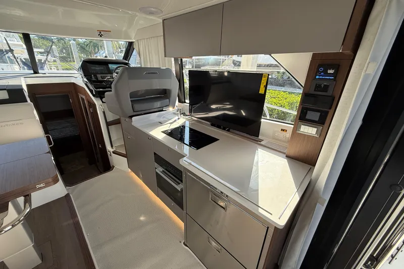 Slide: The Image of Modern interior of 2026 Beneteau Antares 12 yacht with sleek kitchen and navigation area. - 21