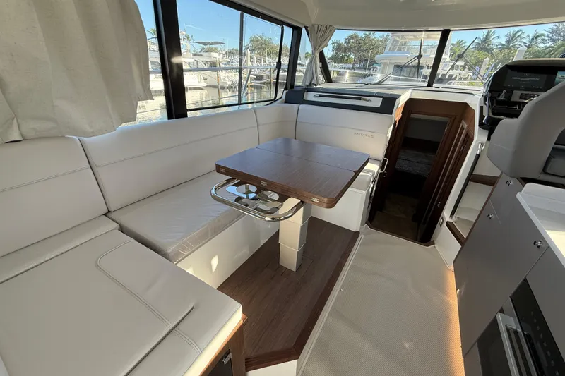 Slide: The Image of Interior of 2026 Beneteau Antares 12 yacht with modern seating and table. - 22