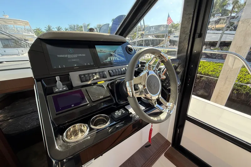 Slide: The Image of Helm of 2026 Beneteau Antares 12 with modern controls and steering wheel. - 25