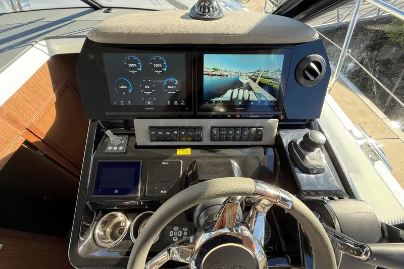 Slide: The Image of 2026 Beneteau Antares 12 helm with advanced navigation displays and controls. - 26