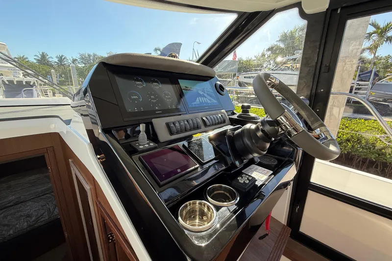 Slide: The Image of Helm of 2026 Beneteau Antares 12 with modern controls and navigation displays. - 27