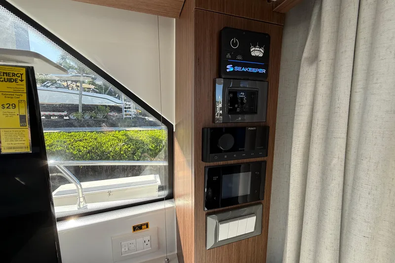 Slide: The Image of Control panel inside 2026 Beneteau Antares 12 yacht, featuring Seakeeper system and energy guide. - 29