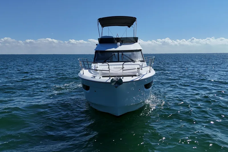 Slide: The Image of 2026 Beneteau Antares 12 yacht cruising on open sea under clear blue sky. - 3