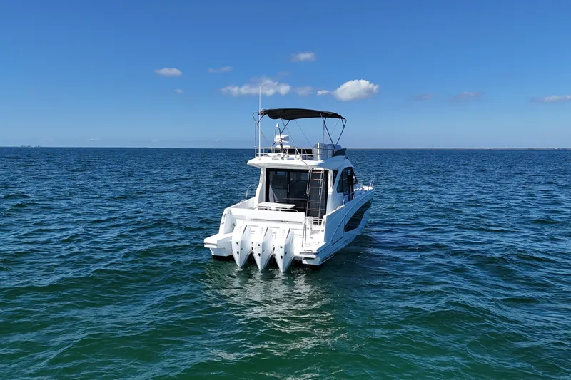 Slide: The Image of 2026 Beneteau Antares 12 yacht on open sea under clear blue sky. - 6