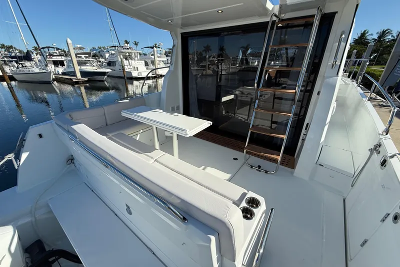 Slide: The Image of 2026 Beneteau Antares 12 yacht with outdoor seating and marina view. - 9