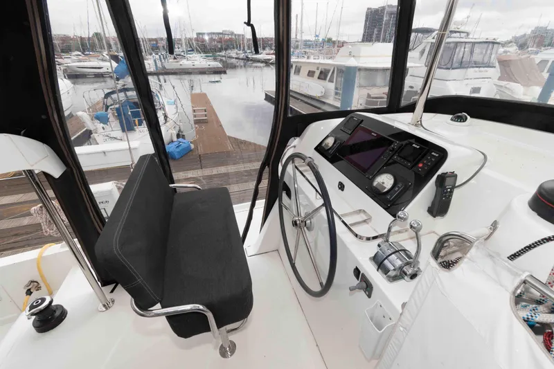Slide: The Image of Cockpit of 2019 Lagoon 42 catamaran with steering wheel and navigation equipment. - 11