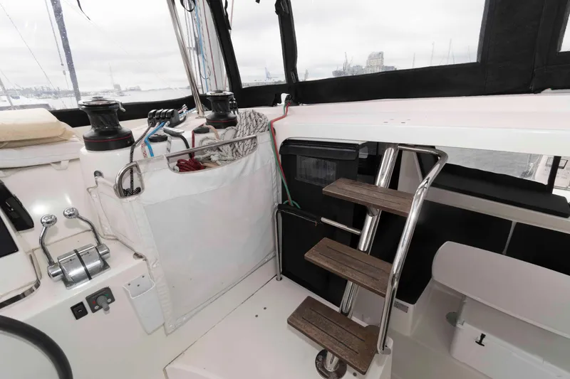 Slide: The Image of Interior view of 2019 Lagoon 42 sailboat cockpit with steps and winches. - 14