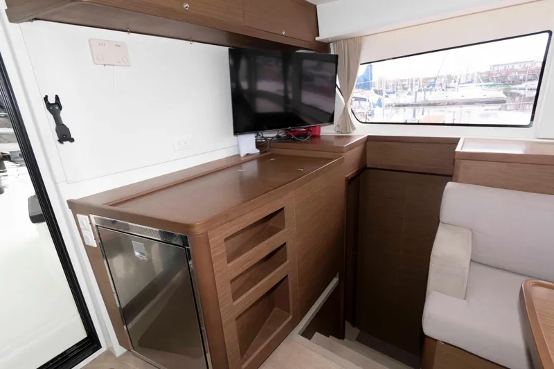 Slide: The Image of Interior of 2019 Lagoon 42 yacht with TV, fridge, and seating area. - 28