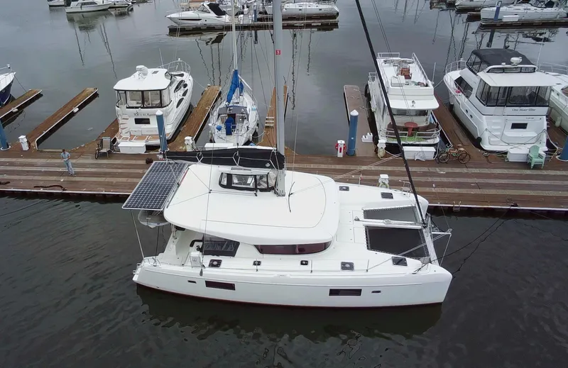 Slide: The Image of 2019 Lagoon 42 catamaran docked at marina with solar panels visible. - 3