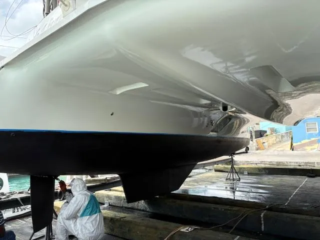 Slide: The Image of 2019 Lagoon 42 catamaran undergoing maintenance in a shipyard. - 39