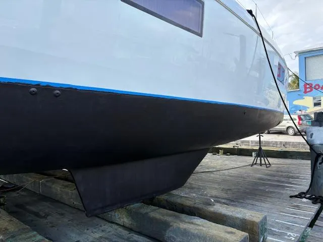 Slide: The Image of 2019 Lagoon 42 catamaran hull on dry dock, showcasing sleek design and structure. - 40