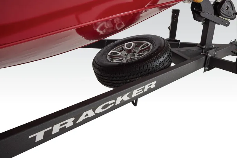 Slide: The Image of Manufacturer Provided Image: 2026 Tracker Savage 215 trailer with spare tire and red boat hull. - 9