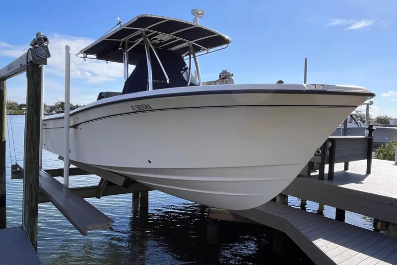 The Image of 2006 Grady-White Release 283 boat on lift, docked by the water. - 1