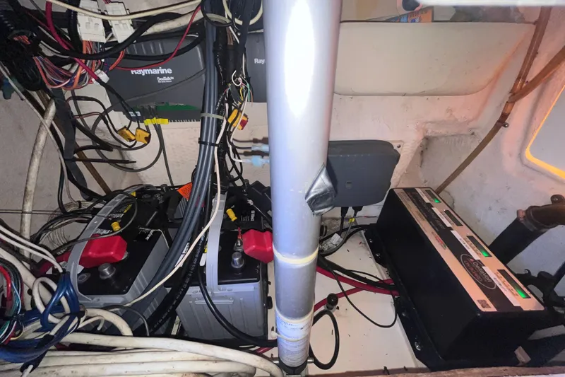 Slide: The Image of Electrical system inside a 2006 Grady-White Release 283 boat, featuring batteries and wiring. - 18