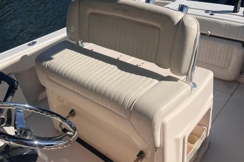 Slide: The Image of 2006 Grady-White Release 283 boat interior with cushioned seating and steering wheel. - 26