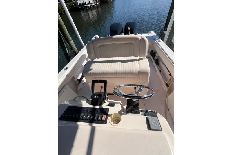 Slide: The Image of 2006 Grady-White Release 283 boat cockpit with steering wheel and controls. - 29