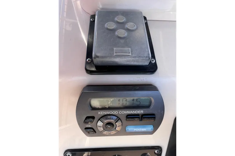 Slide: The Image of Kenwood Commander audio system on 2006 Grady-White Release 283 boat dashboard. - 31