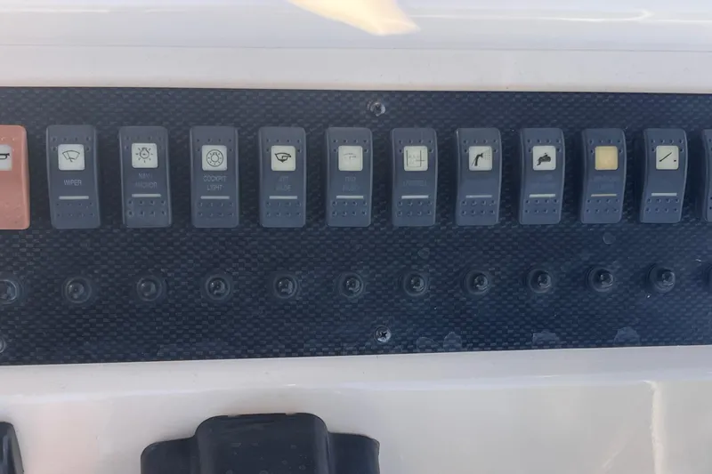 Slide: The Image of Control panel of a 2006 Grady-White Release 283 boat with labeled switches. - 32
