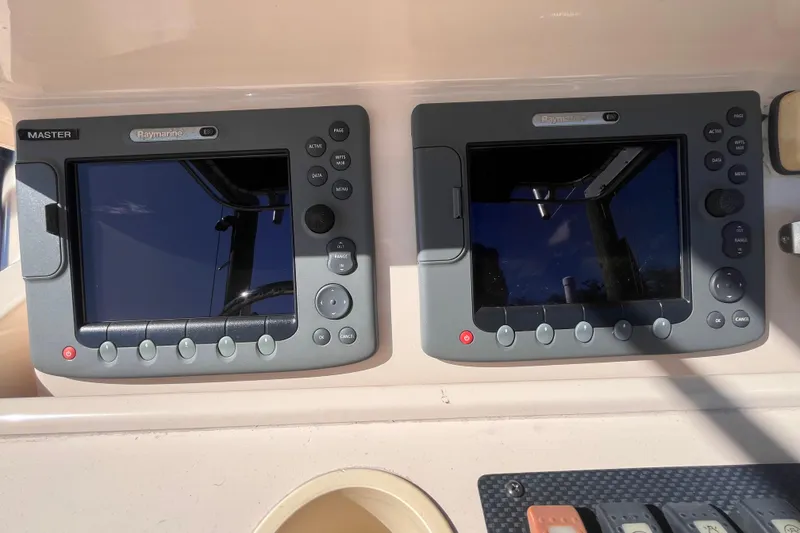 Slide: The Image of 2006 Grady-White Release 283 boat dashboard with dual Raymarine E80 displays. - 33