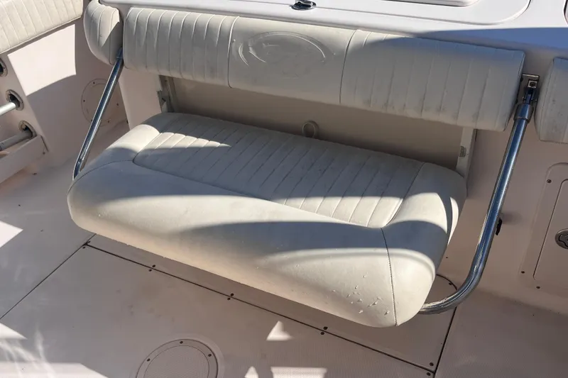Slide: The Image of 2006 Grady-White Release 283 boat seat with metal supports in sunlight. - 36