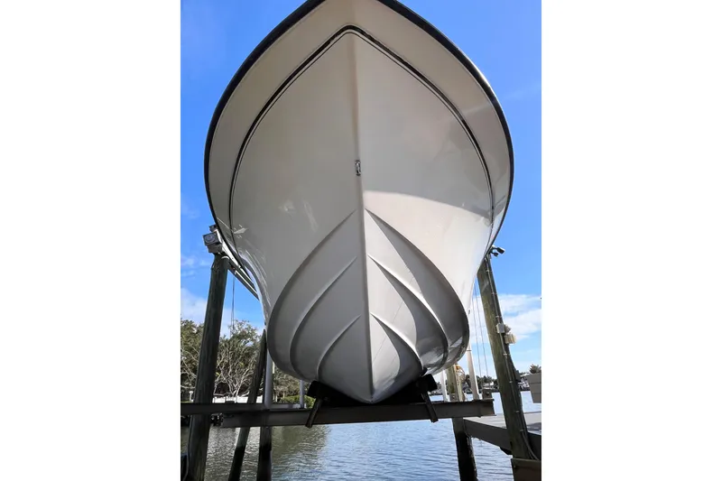 Slide: The Image of 2006 Grady-White Release 283 boat on lift, viewed from below, against blue sky. - 4