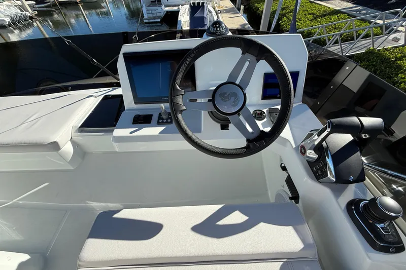 Slide: The Image of Helm of 2026 Beneteau Antares 12 with modern controls and navigation screens. - 17