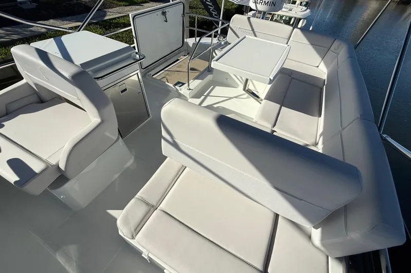 Slide: The Image of Luxurious seating area on 2026 Beneteau Antares 12 yacht, featuring sleek white upholstery. - 19