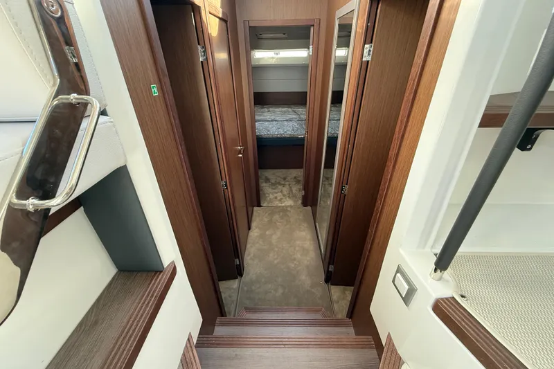 Slide: The Image of Interior of 2026 Beneteau Antares 12, featuring wood finishes and cozy cabin layout. - 30