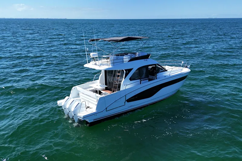 Slide: The Image of 2026 Beneteau Antares 12 yacht cruising on open sea under clear blue sky. - 4