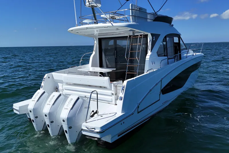 Slide: The Image of 2026 Beneteau Antares 12 yacht with triple outboard engines on open water. - 5