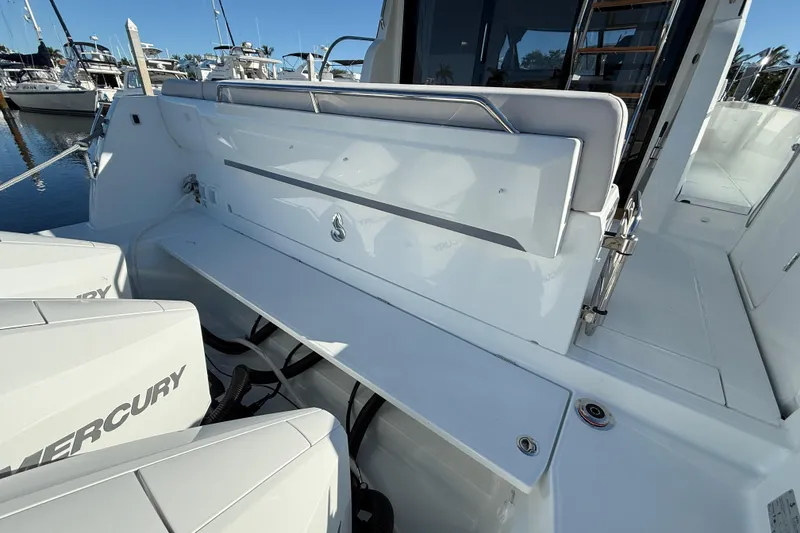 Slide: The Image of 2026 Beneteau Antares 12 boat deck with Mercury engines, docked at marina. - 8