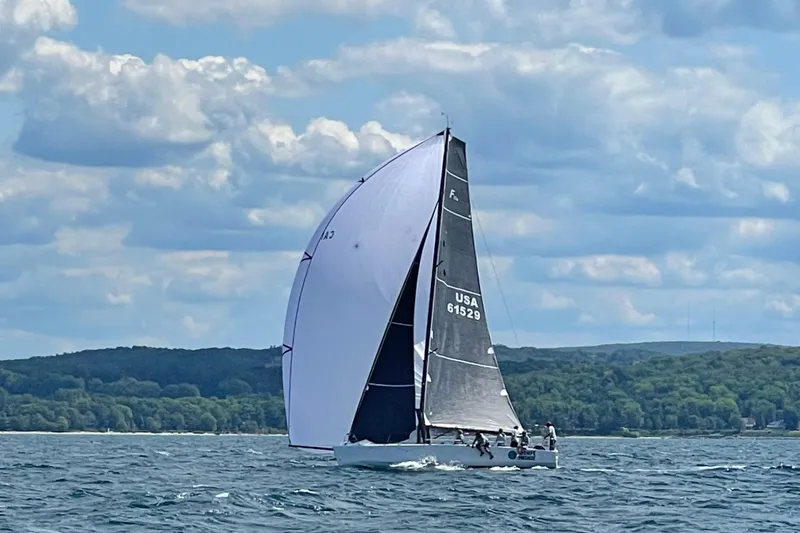 Slide: The Image of Sailboat Farr 11s 2009 on open water with scenic cloudy sky. - 12