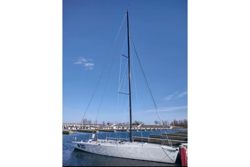 Slide: The Image of Sleek 2009 Farr 11s sailboat docked under clear blue sky. - 3