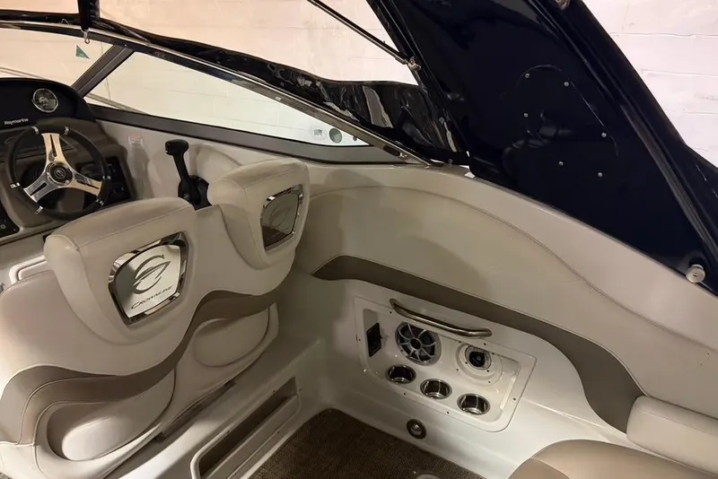 Slide: The Image of Interior of 2019 Crownline 264 CR boat with steering wheel and seating. - 11