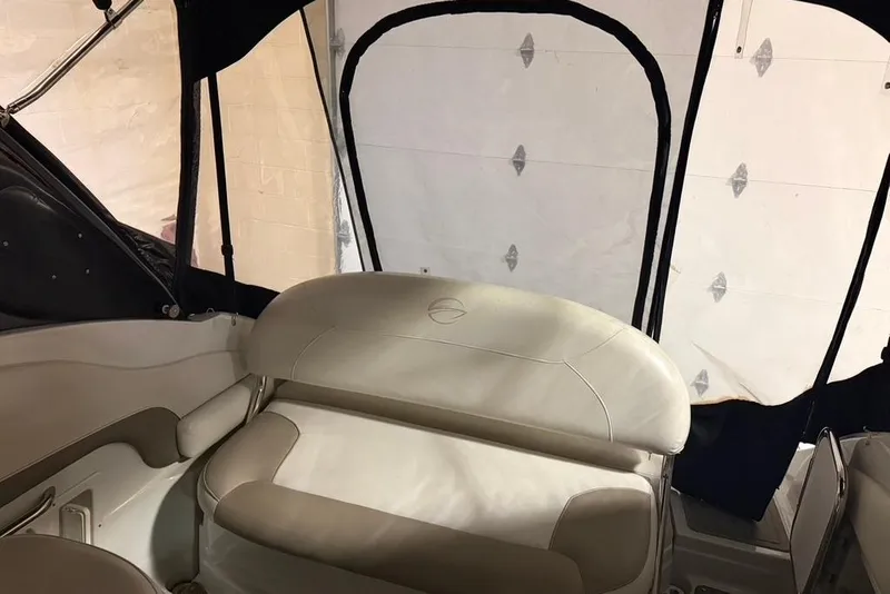 Slide: The Image of 2019 Crownline 264 CR boat interior with beige seating and black canopy. - 12
