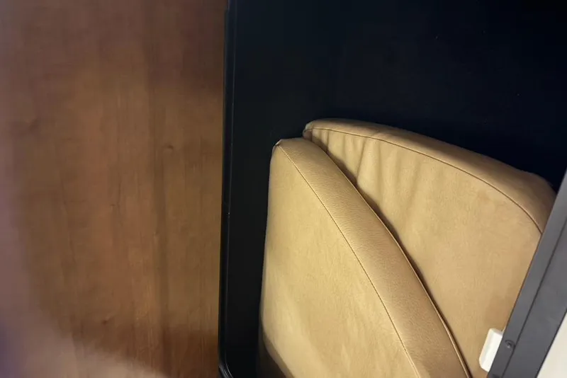 Slide: The Image of Crownline 264 CR 2019 interior with beige cushions and wooden paneling. - 13