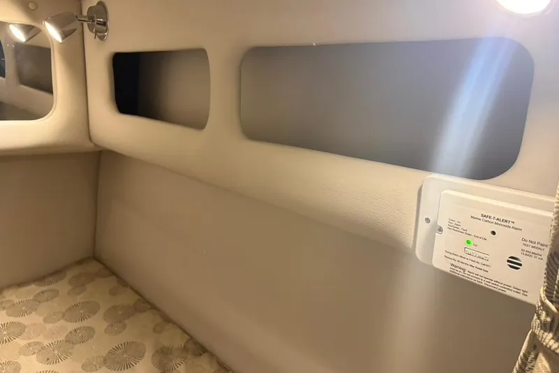 Slide: The Image of Interior of 2019 Crownline 264 CR boat cabin with lighting and carbon monoxide alarm. - 23