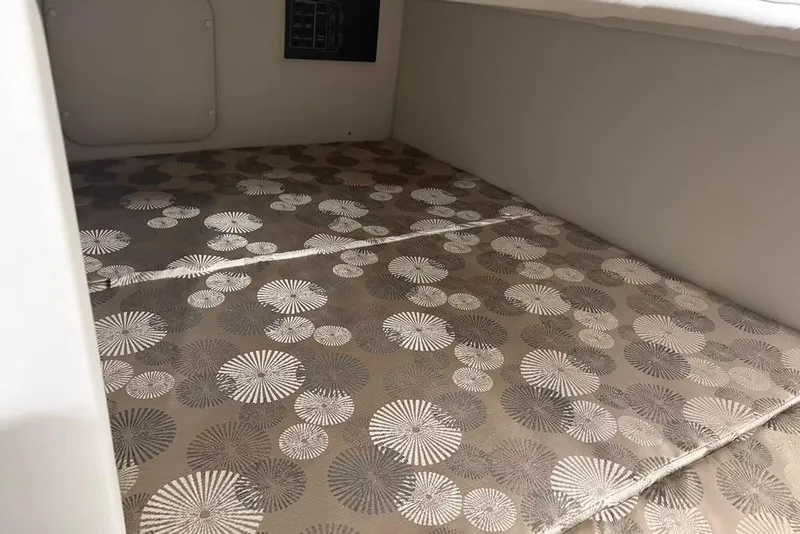 Slide: The Image of 2019 Crownline 264 CR cabin interior with patterned upholstery. - 24