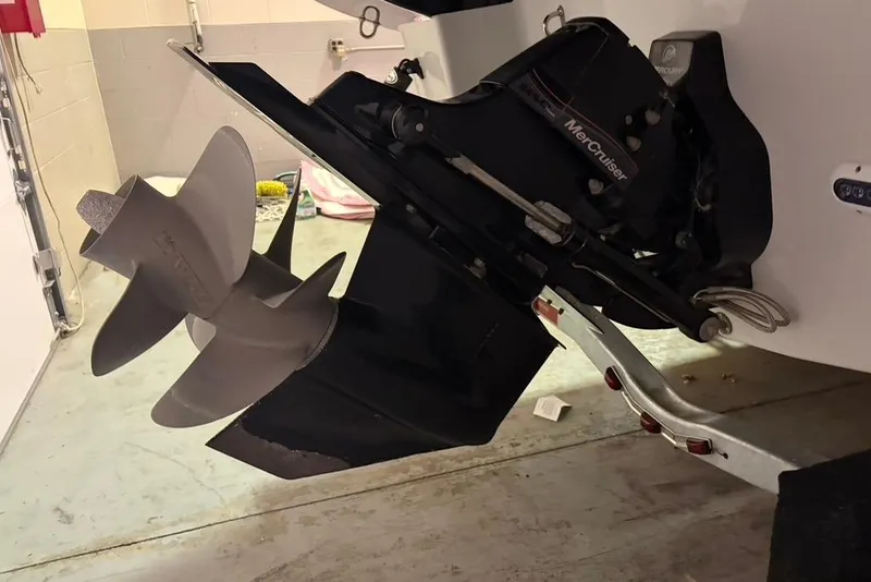 Slide: The Image of 2019 Crownline 264 CR boat with MerCruiser engine and propeller in a garage. - 31