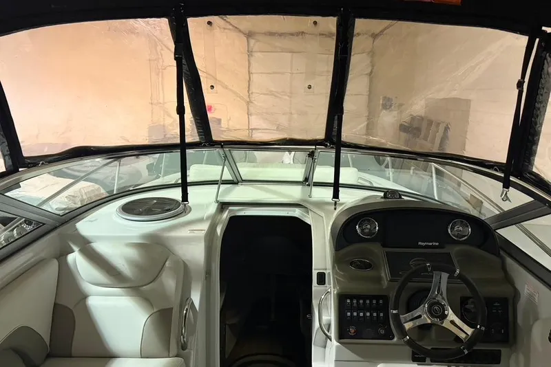 Slide: The Image of 2019 Crownline 264 CR boat interior with steering wheel and dashboard controls. - 4