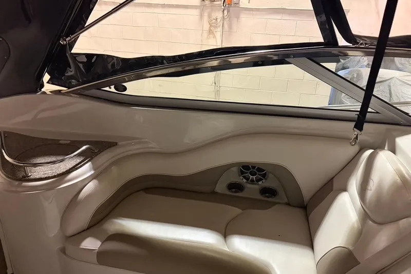 Slide: The Image of 2019 Crownline 264 CR boat interior with beige seating and speaker system. - 6