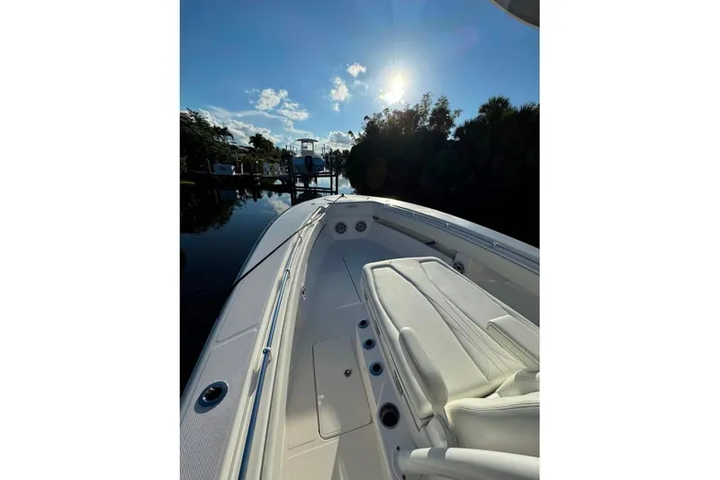 The Image of 2024 Invincible 33 Open Fisherman boat on calm water under a bright sun. - 0