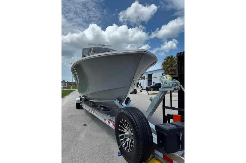 Slide: The Image of 2024 Invincible 33 Open Fisherman boat on trailer under blue sky. - 1