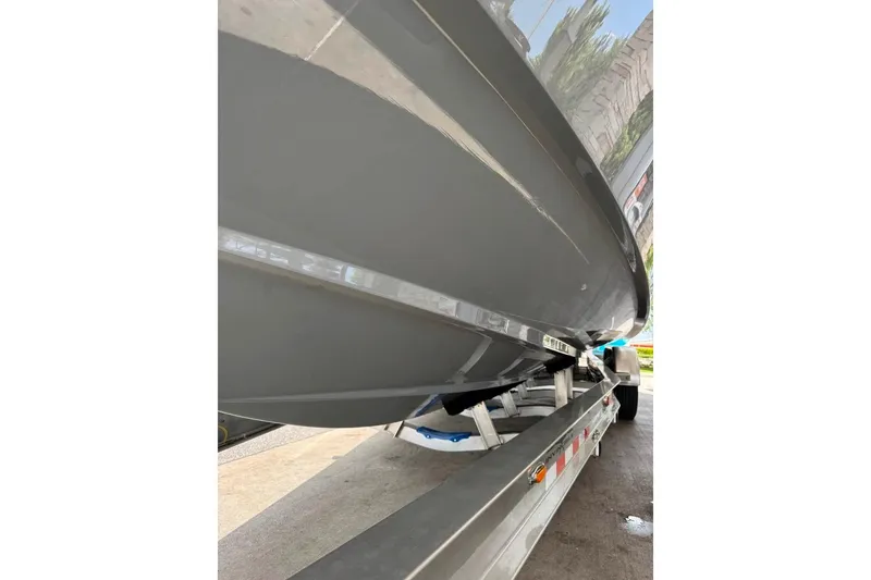 Slide: The Image of 2024 Invincible 33 Open Fisherman boat on trailer, showcasing sleek hull design. - 2