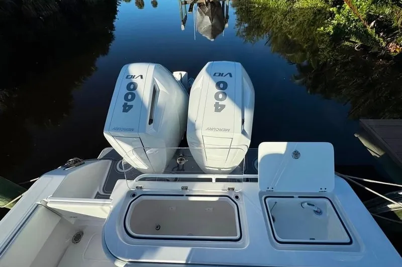 Slide: The Image of 2024 Invincible 33 Open Fisherman with twin 400 Mercury outboard engines on calm water. - 7
